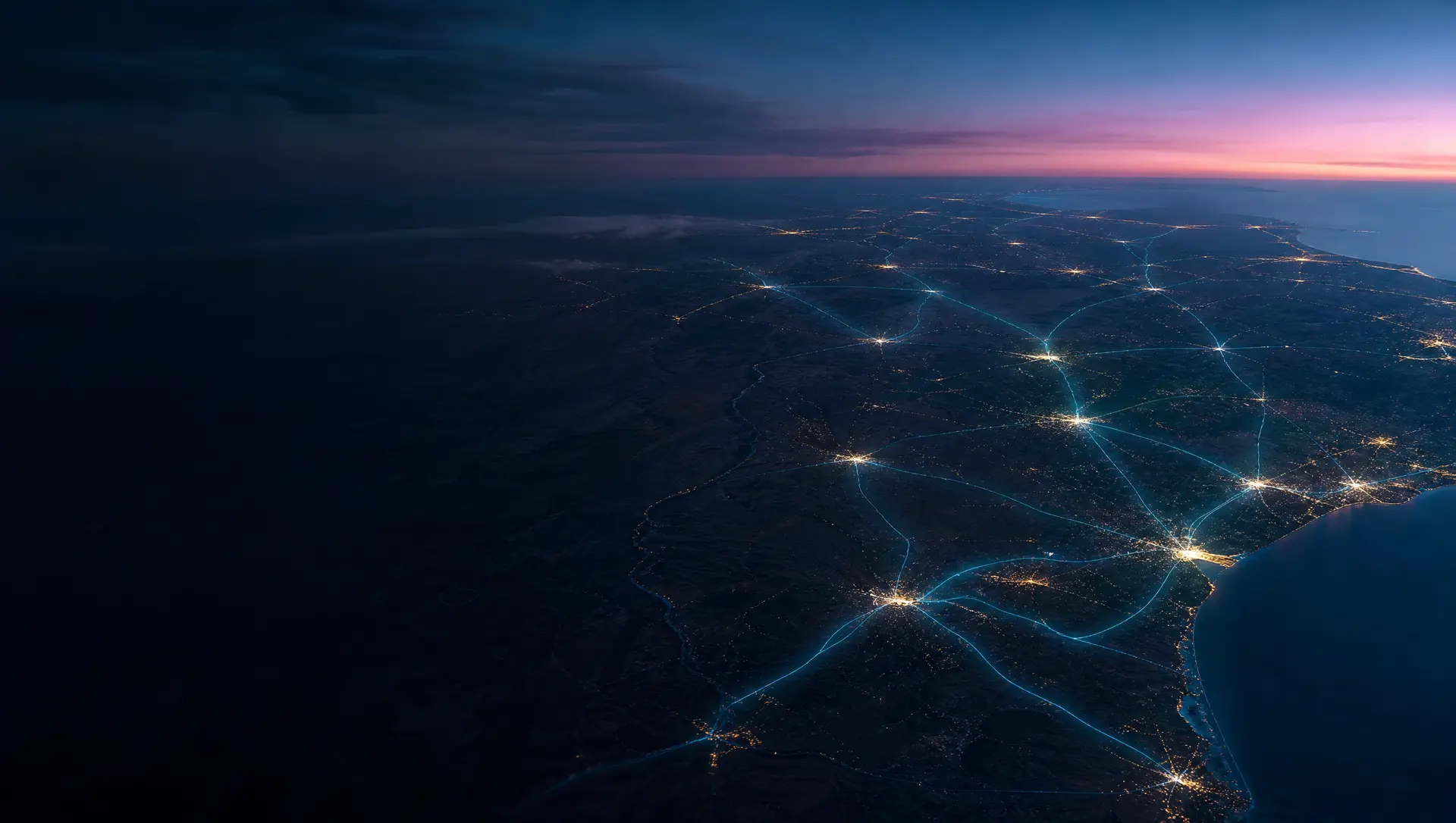 Texas seen from high above at dusk with city lights connected by threads of light, representing statewide service